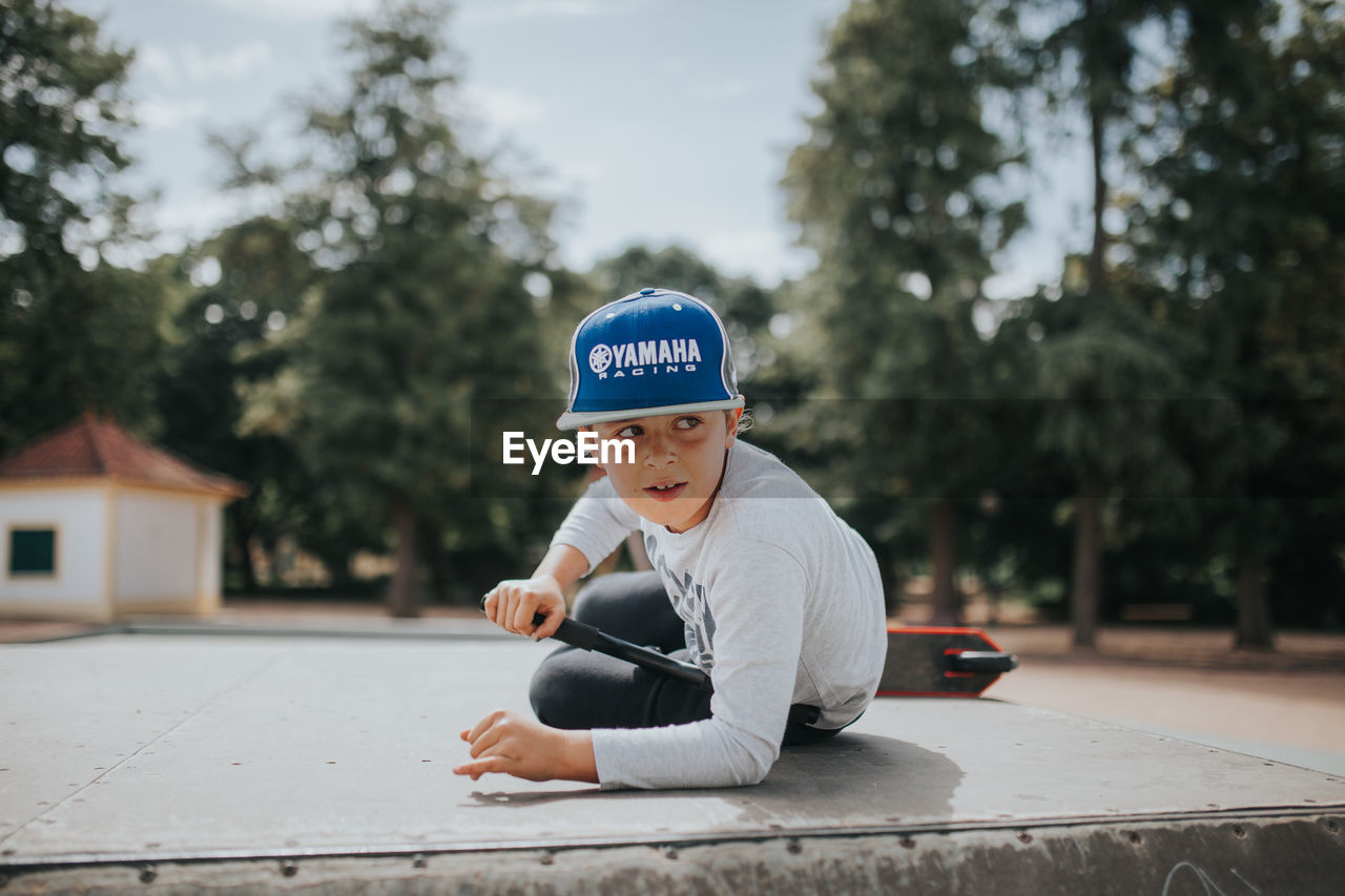 BOY WEARING HAT AGAINST SKY