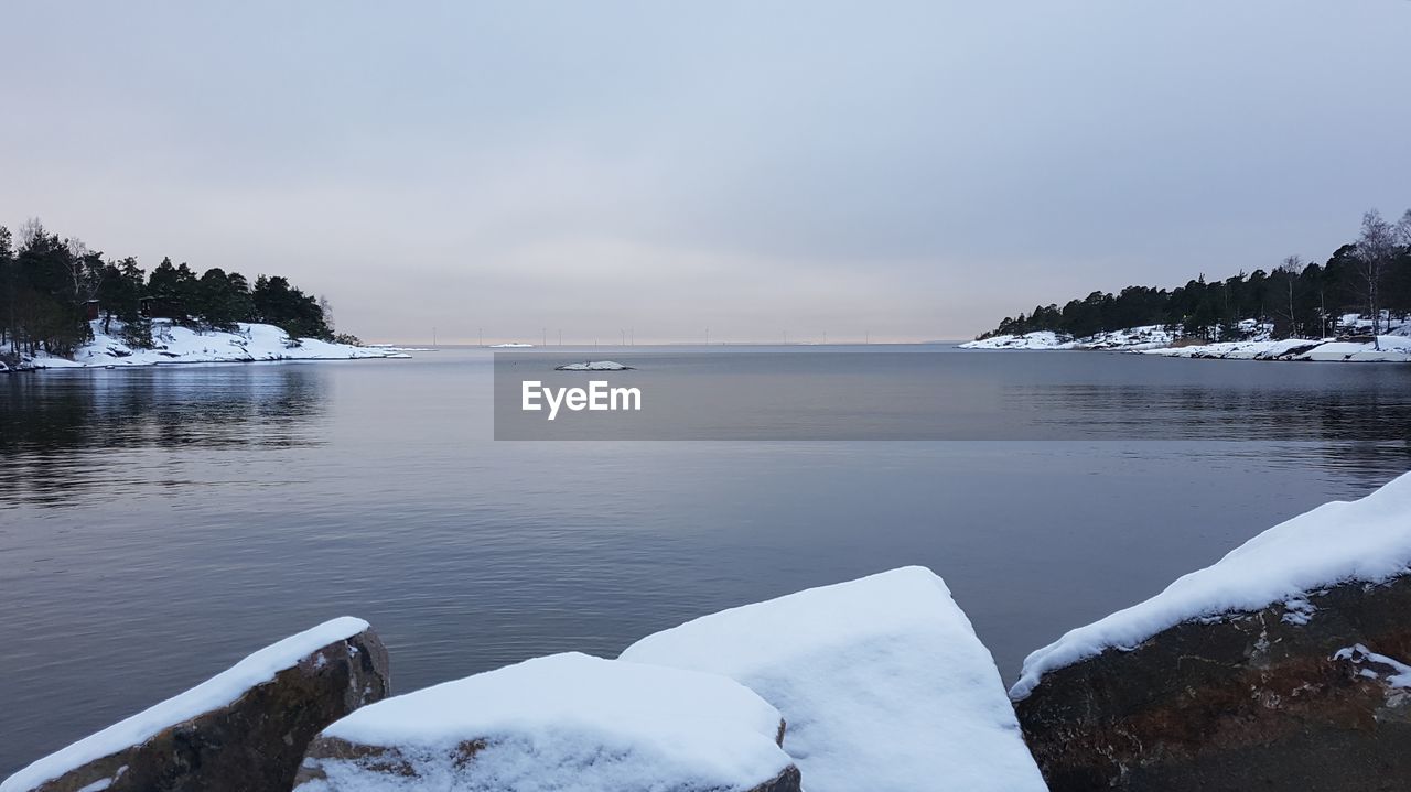 Scenic view of frozen lake against sky