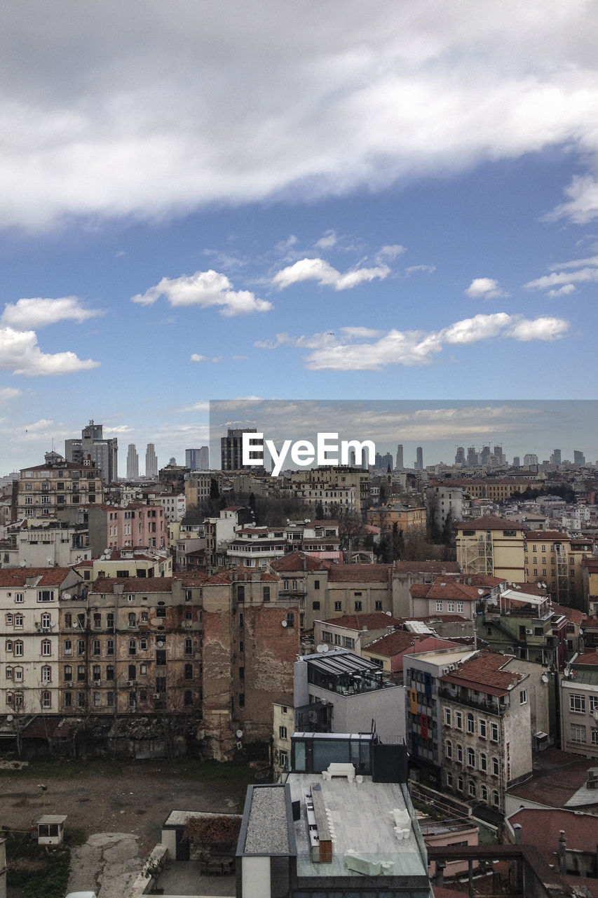 Cityscape against cloudy sky