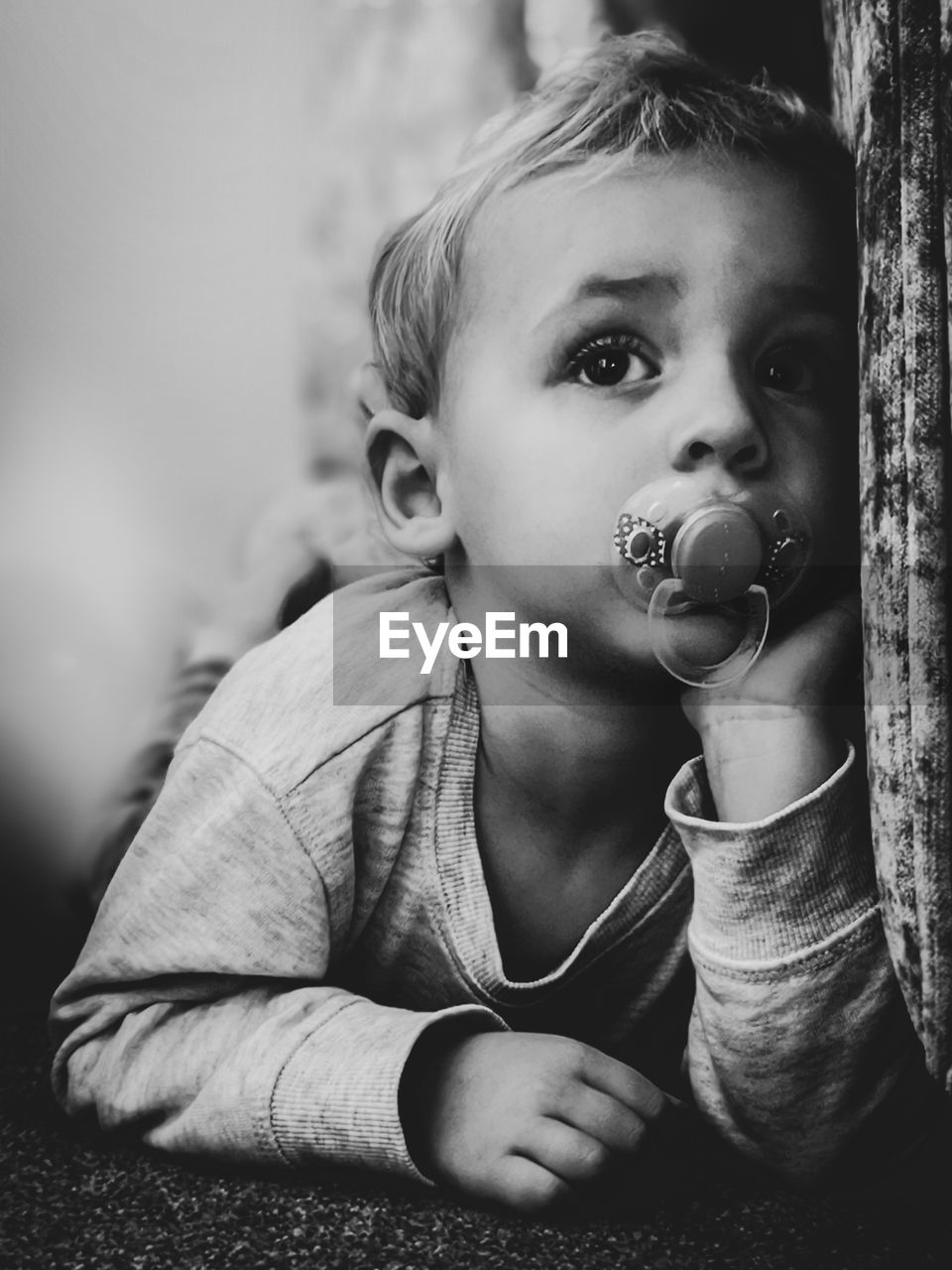 Close-up of cute boy with pacifier in mouth