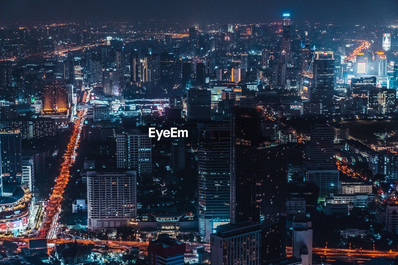 Aerial view of illuminated buildings in city at night