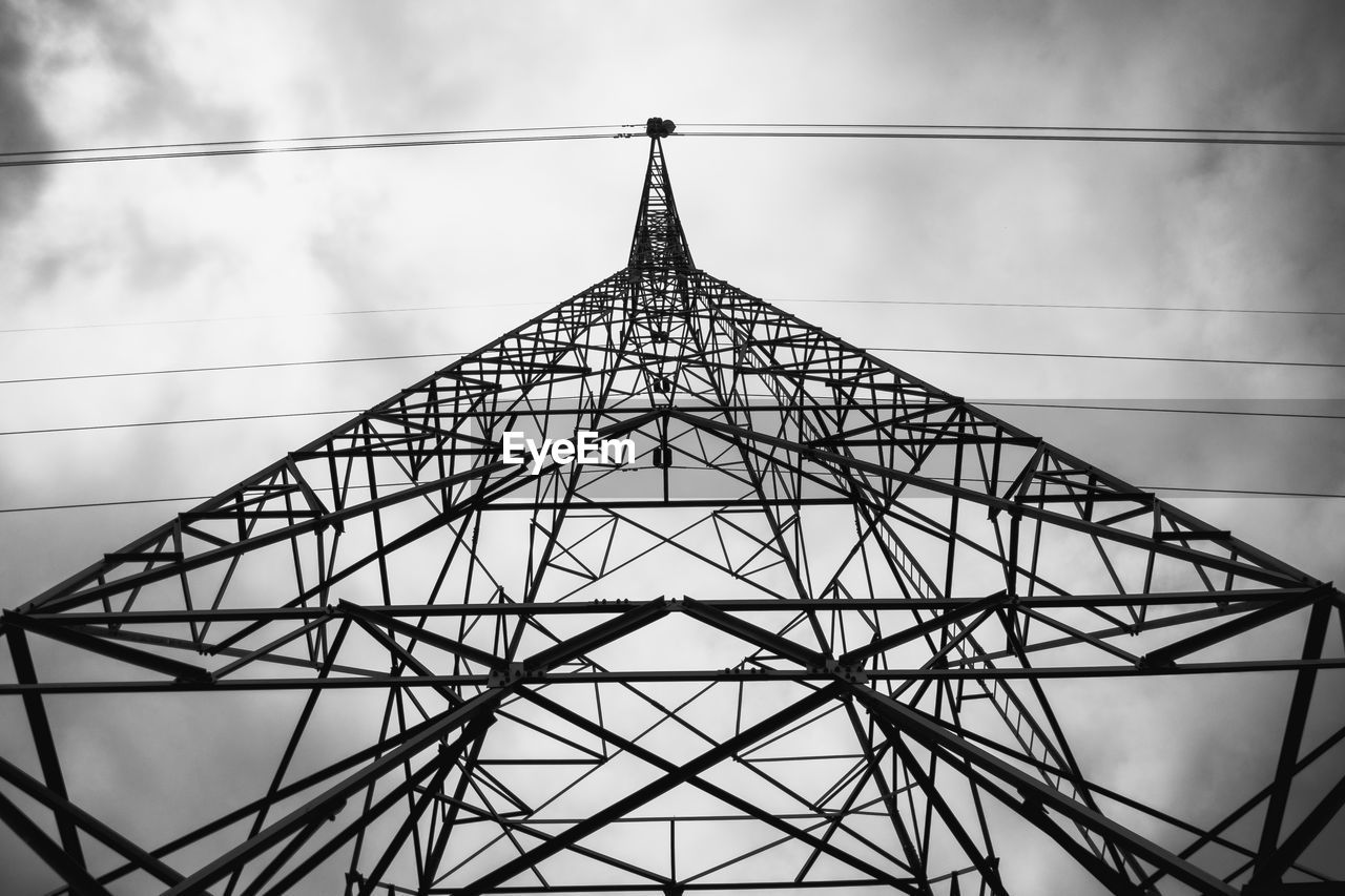 Low angle view of electricity pylon against sky