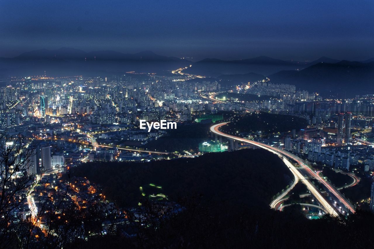 High angle view of illuminated buildings in city at night