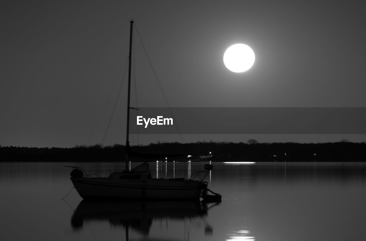 BOATS IN LAKE AT NIGHT