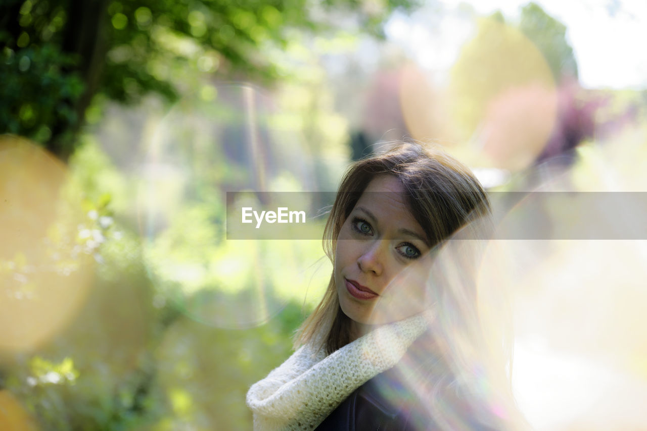 Portrait of young woman looking away outdoors