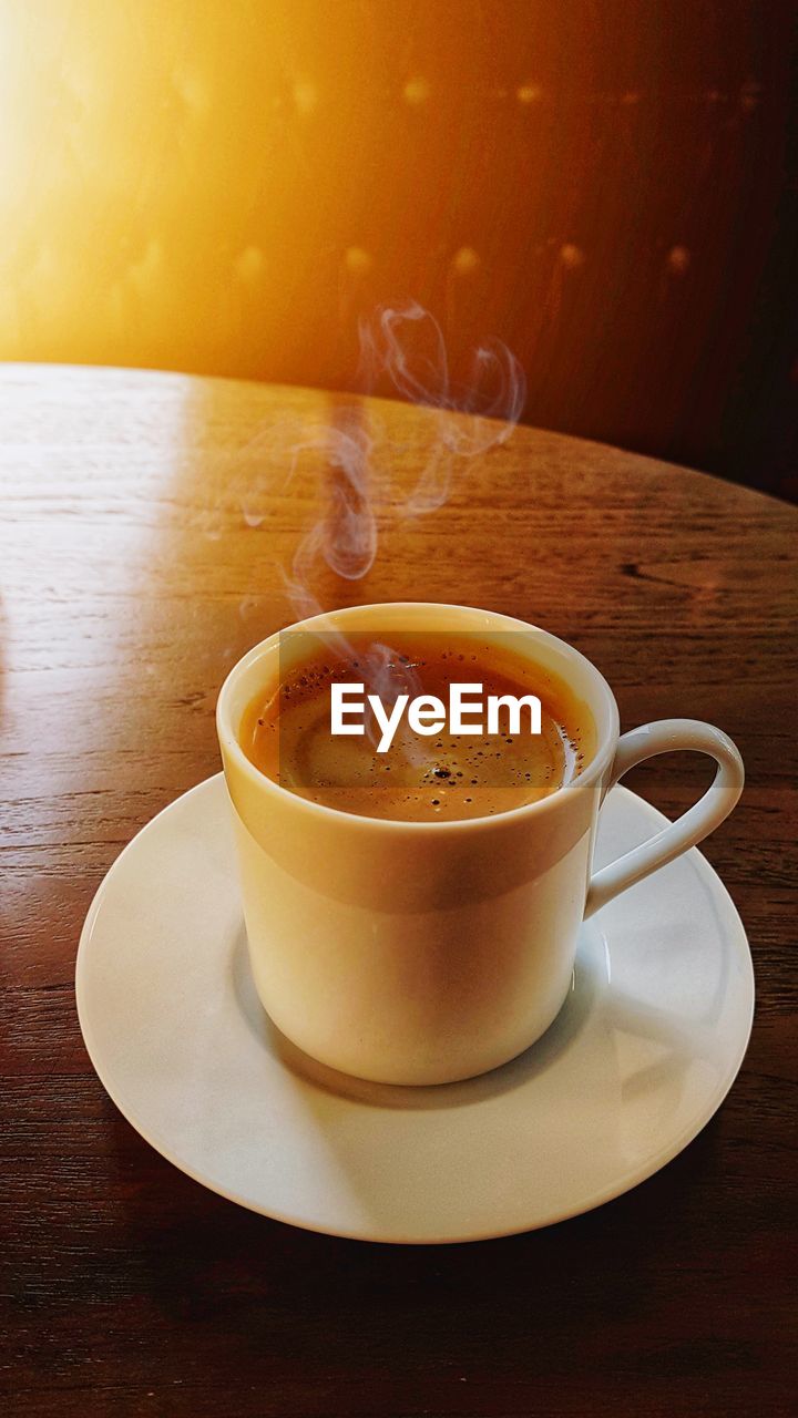 CLOSE-UP OF COFFEE CUP AND TEA ON TABLE