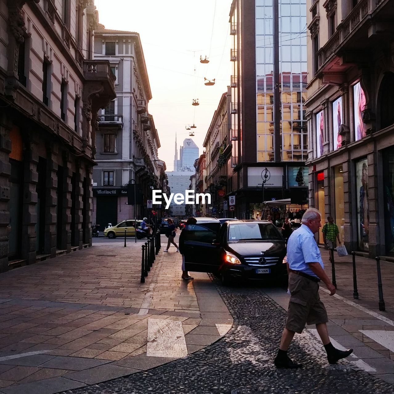 MAN WORKING ON STREET AGAINST SKY