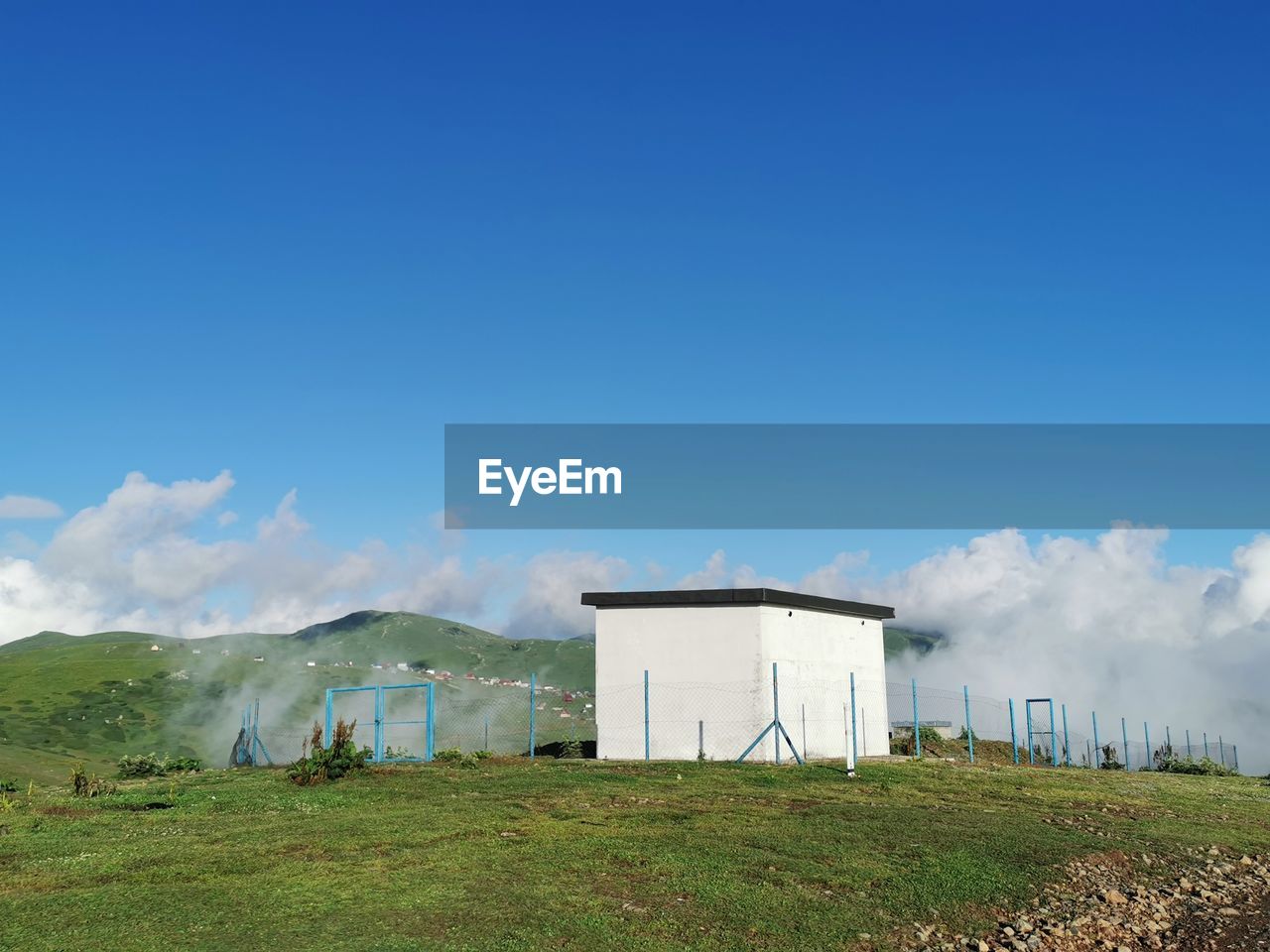 Built structure on field against sky