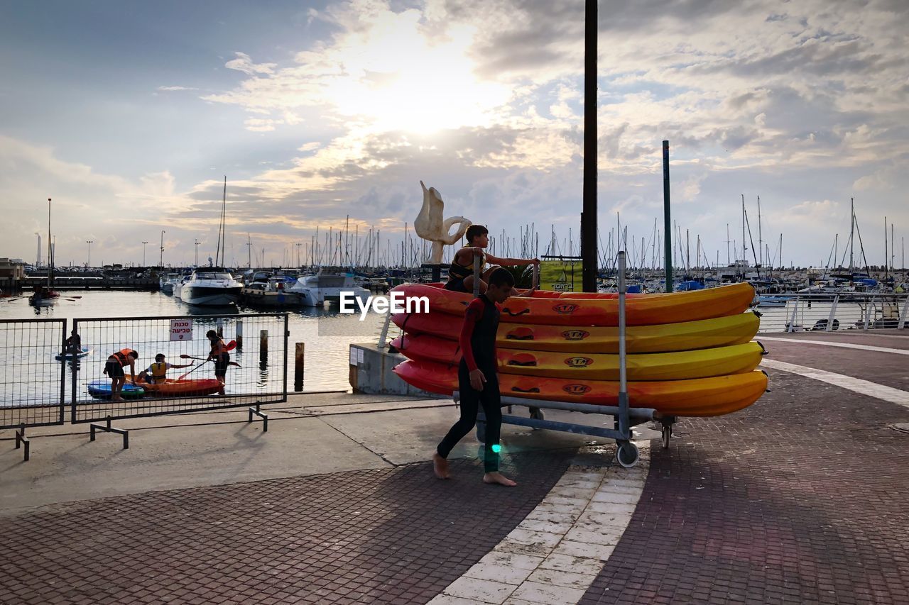 MAN ON HARBOR AGAINST SKY