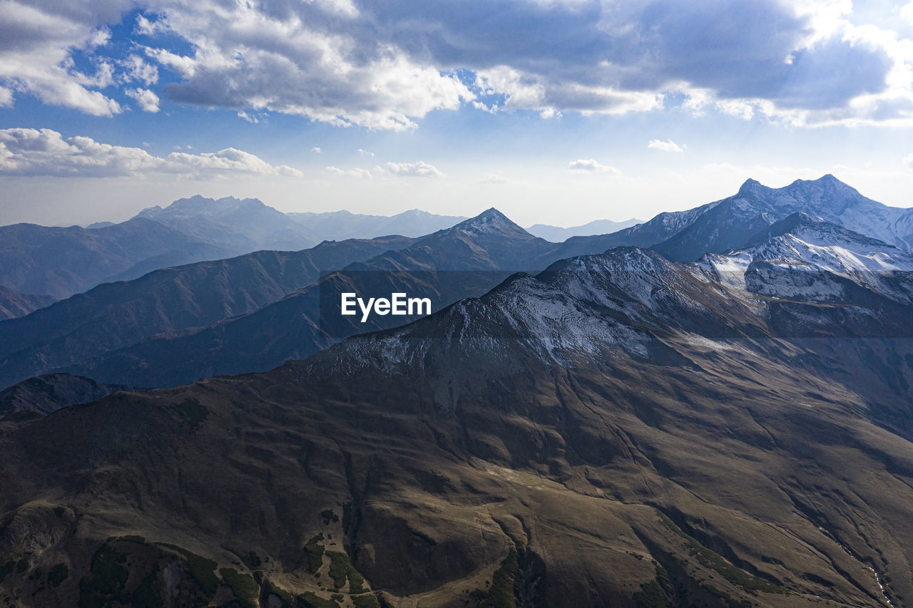 SCENIC VIEW OF DRAMATIC LANDSCAPE AGAINST SKY DURING WINTER