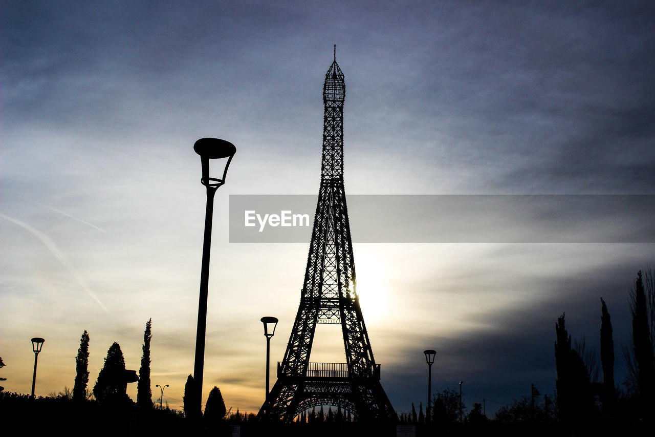 Low angle view of silhouette replica eiffel tower against sky during sunset