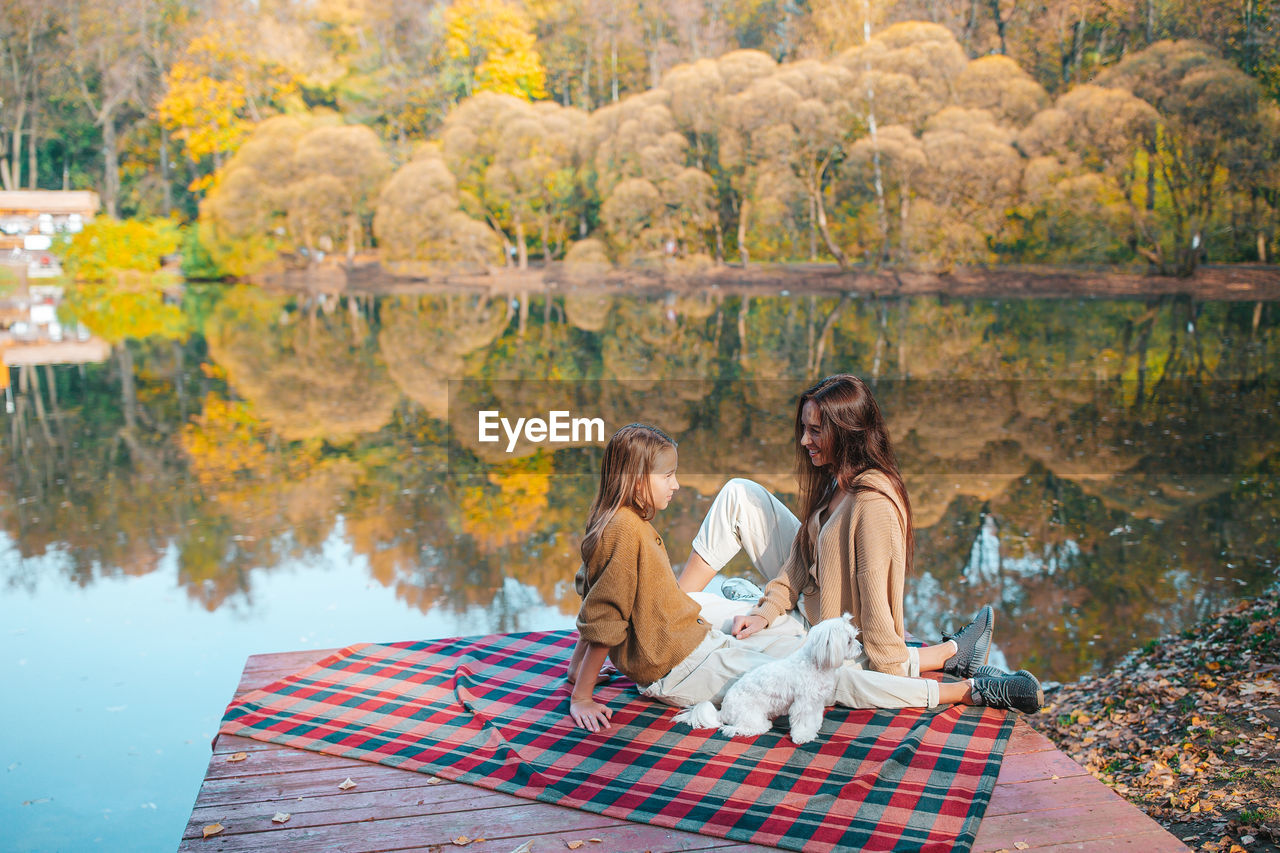 Family sitting by lake