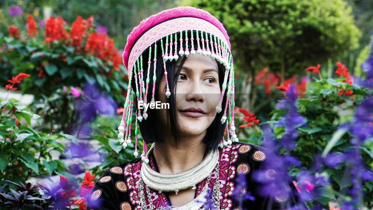 Woman in traditional clothing wearing headwear at park