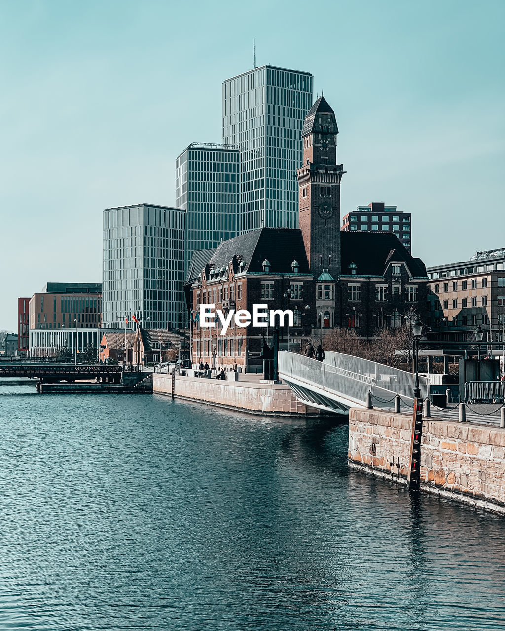 VIEW OF BUILDINGS BY RIVER AGAINST SKY