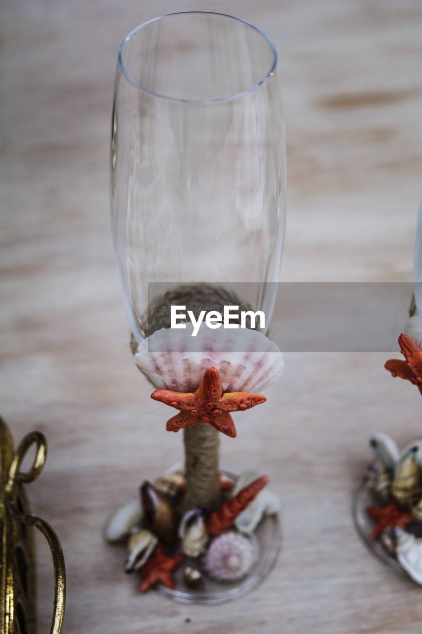 High angle view of champagne flute with seashells on table