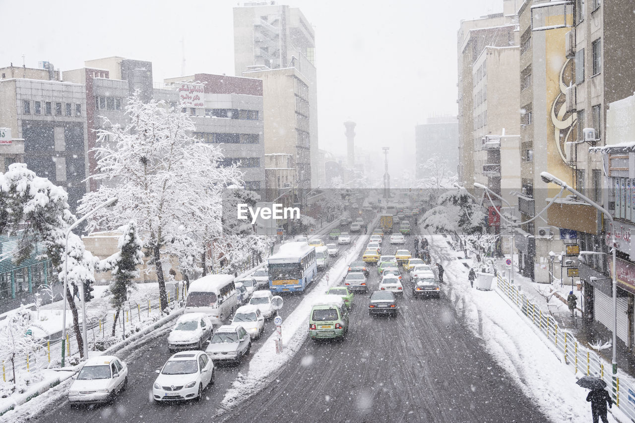 Dr fatemi street tehran, iran - january 28, 2018 cars passing through street on snowy wintry day