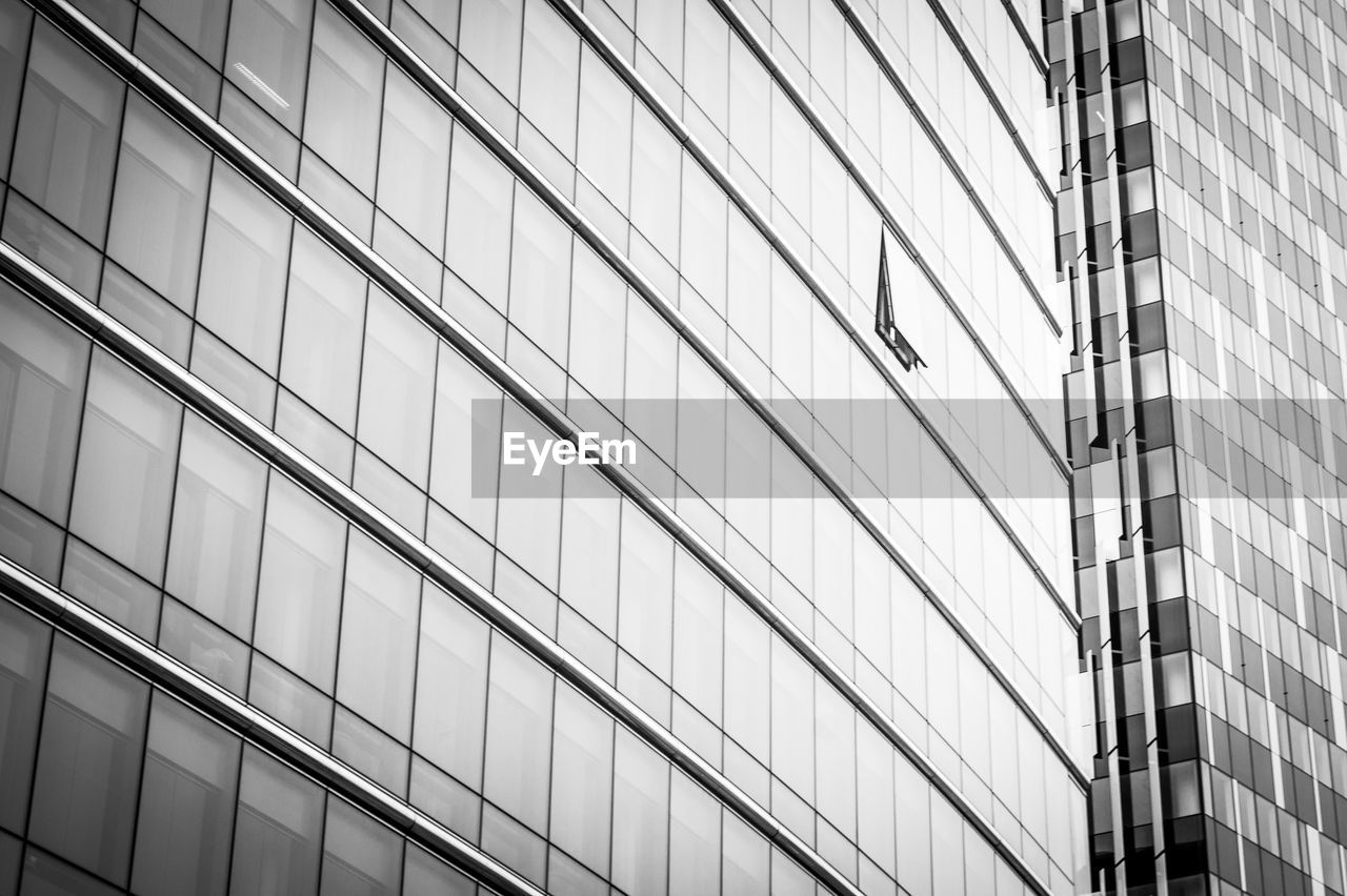 Low angle view of modern glass building in city