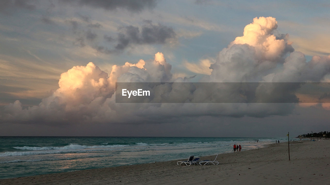 PANORAMIC VIEW OF BEACH AGAINST SKY DURING SUNSET