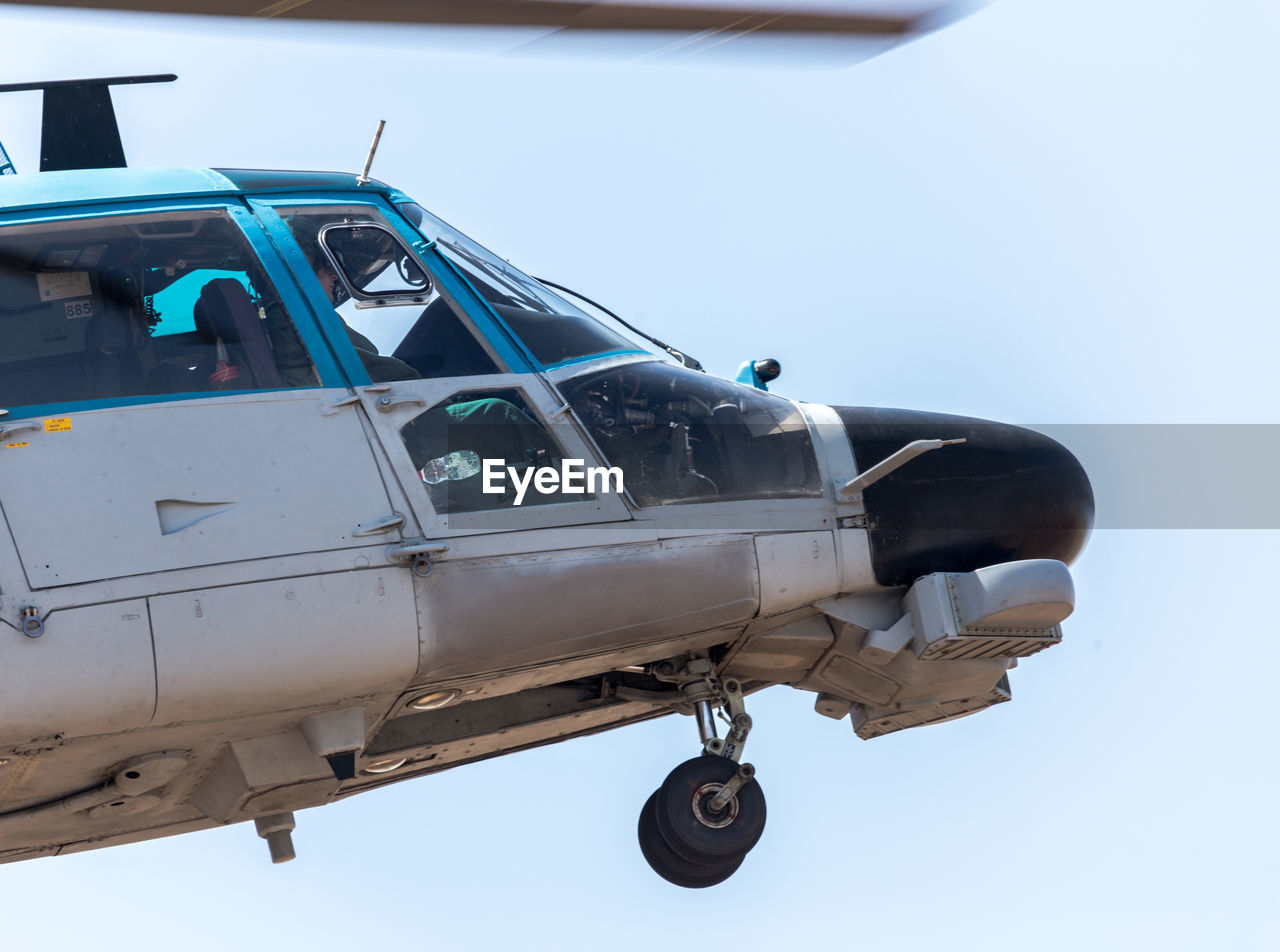 Low angle view of helicopter against sky