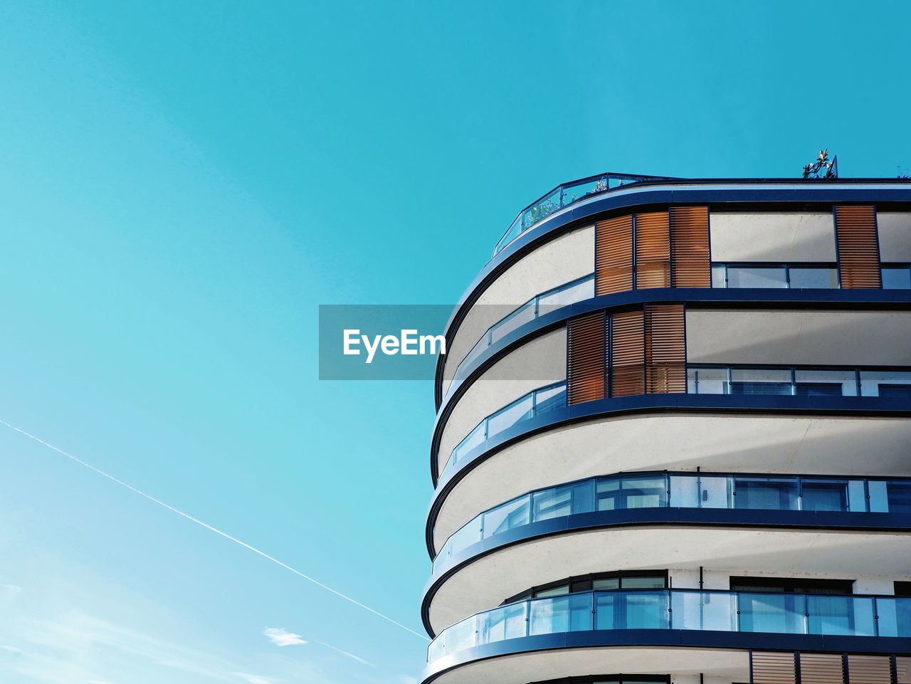 Low angle view of modern building against clear blue sky