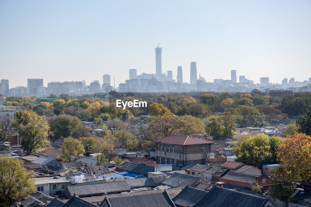 High angle view of trees and buildings against clear sky