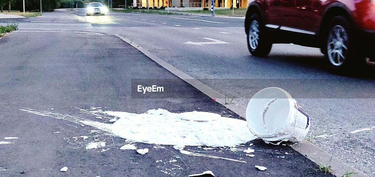 CLOSE-UP OF CAR ON ROAD