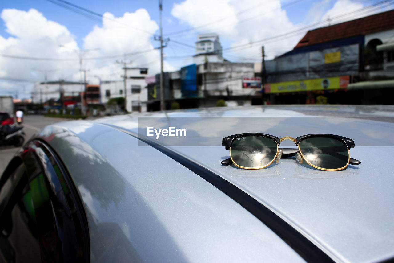 REFLECTION OF SUNGLASSES ON GLASS