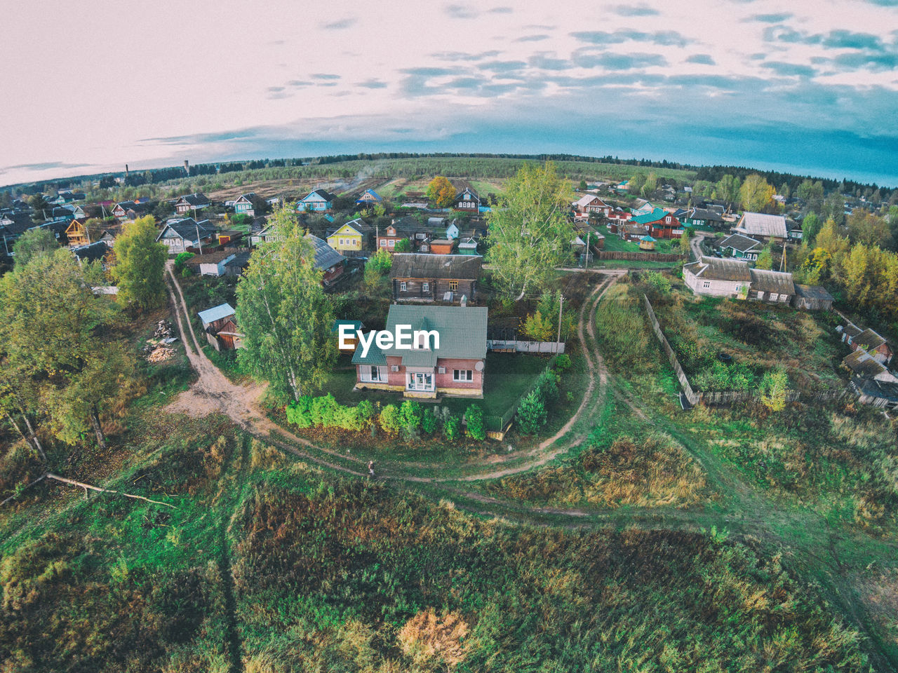 Fish-eye view of townscape against sky during sunset