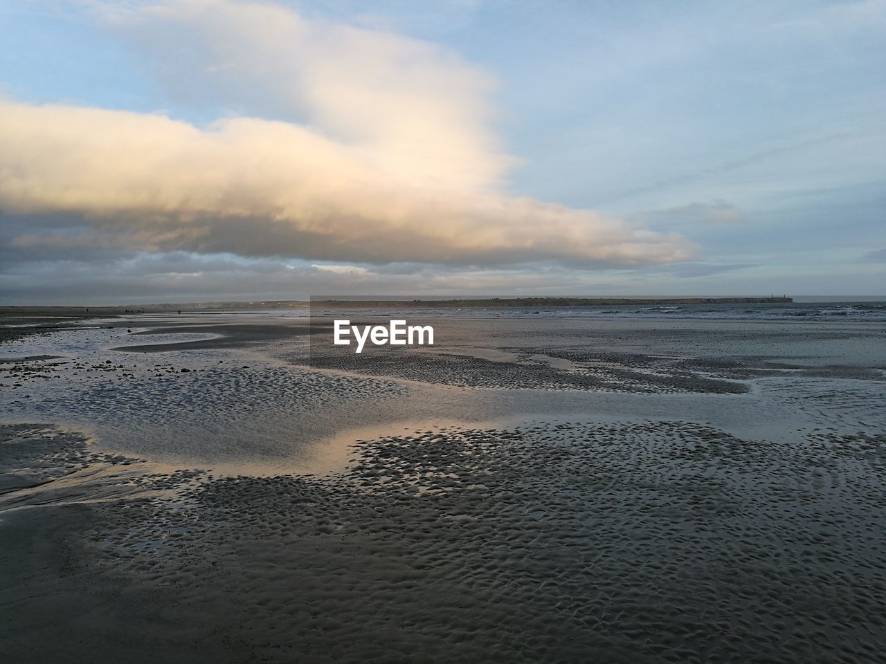 Scenic view of beach against sky during sunset