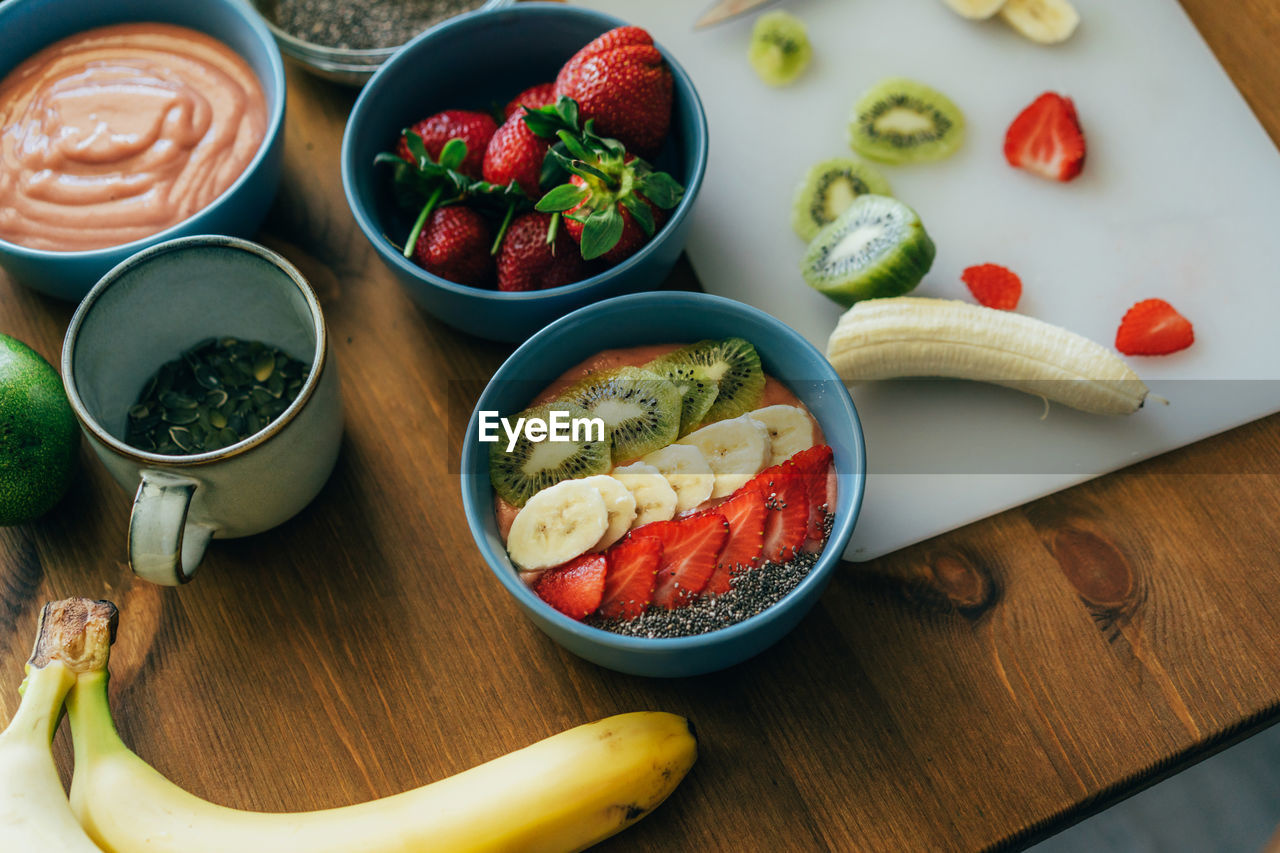 Bowls with ground fruit and berry healthy smoothies. ready-made dessert decorated with summer fruits