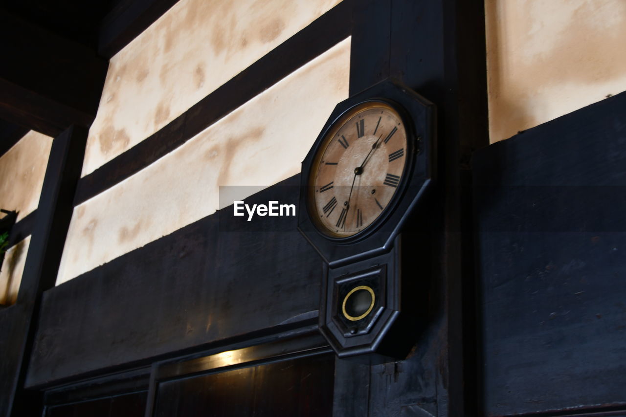 clock, time, no people, black, low angle view, clock face, lighting, architecture, light, wall clock, interior design, wood, wall, wall - building feature, white, built structure, instrument of time