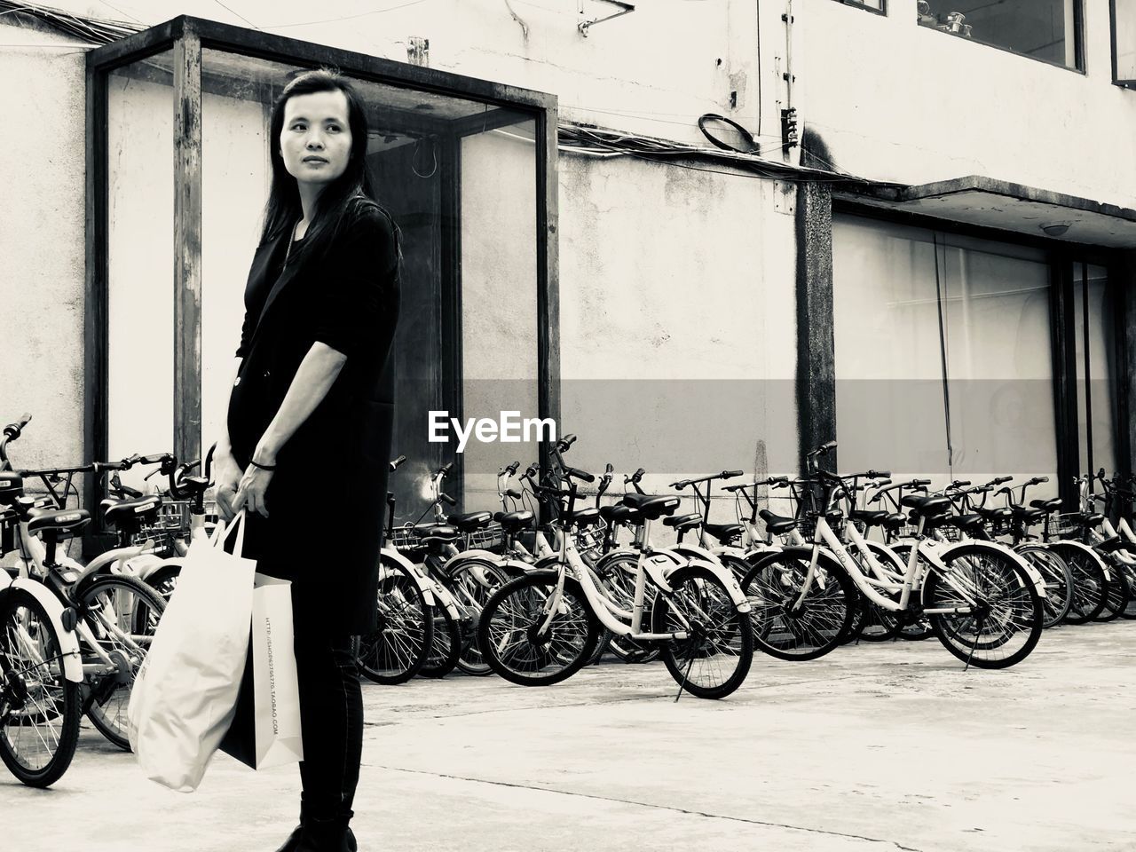 FULL LENGTH PORTRAIT OF WOMAN STANDING WITH GRAFFITI