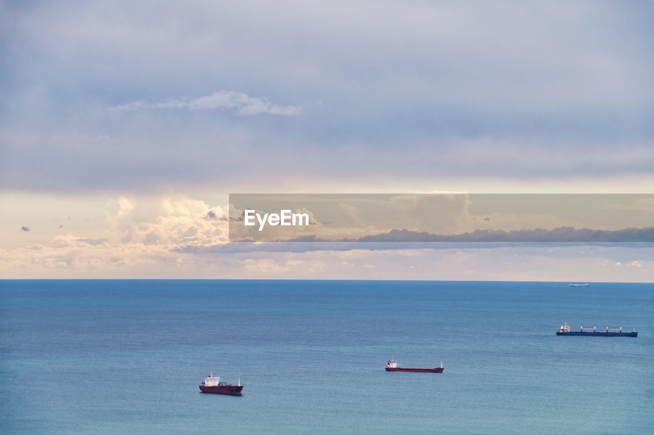 Scenic view of sea and fright transportation with ships against sky