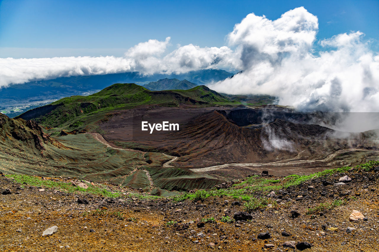 Scenic view on volcanic landscape, clouds in aso crater, aso town in kyushu, japan