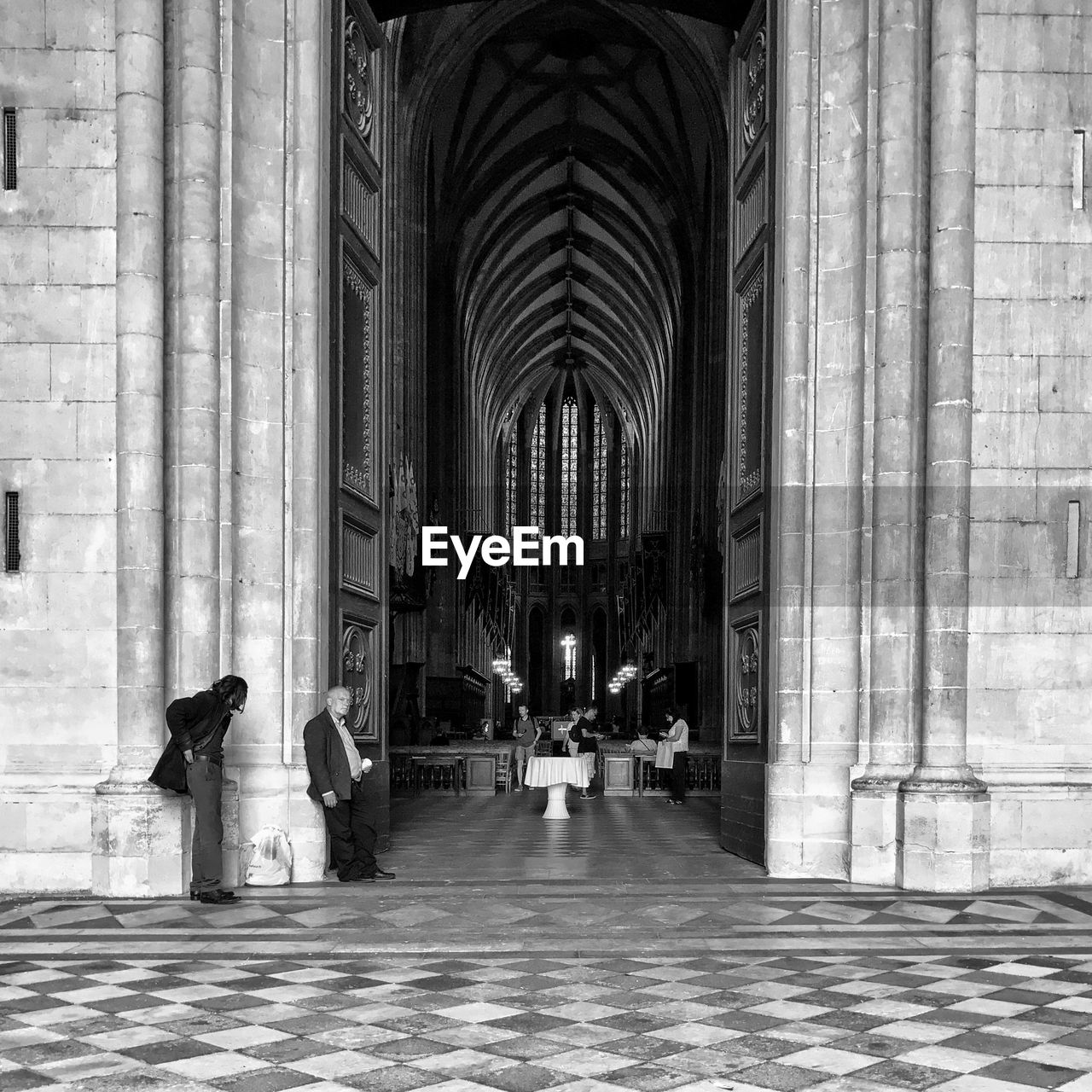 PEOPLE IN CORRIDOR OF CATHEDRAL