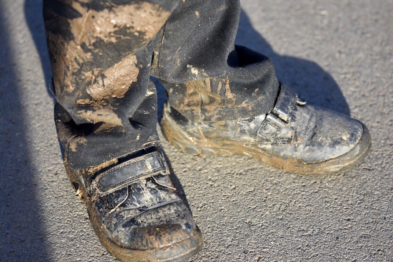 CLOSE-UP OF SHOES ON SAND