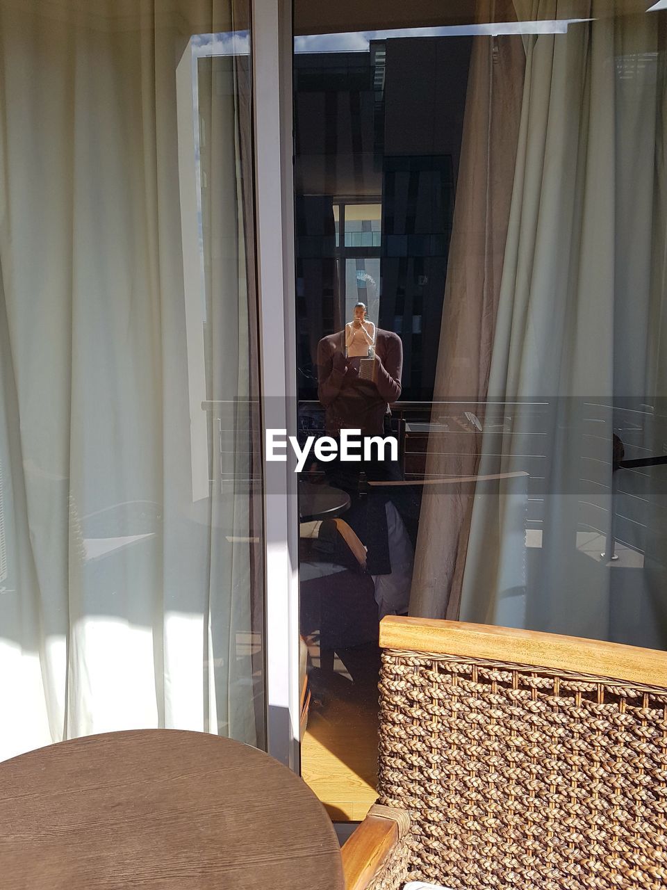 MAN SEEN THROUGH WINDOW IN OFFICE