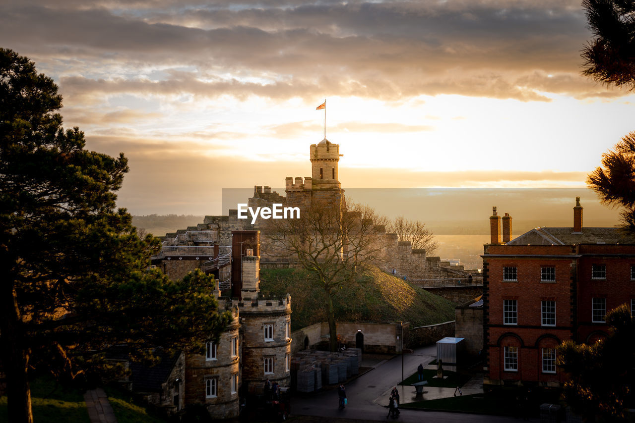 HIGH ANGLE VIEW OF BUILDINGS AT SUNSET