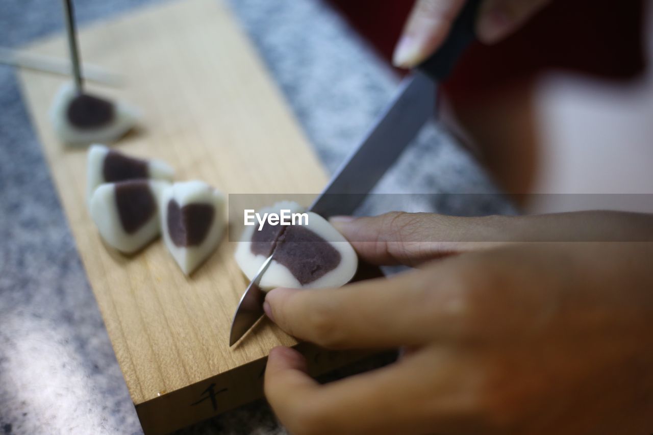 Cropped hands preparing food on kitchen counter