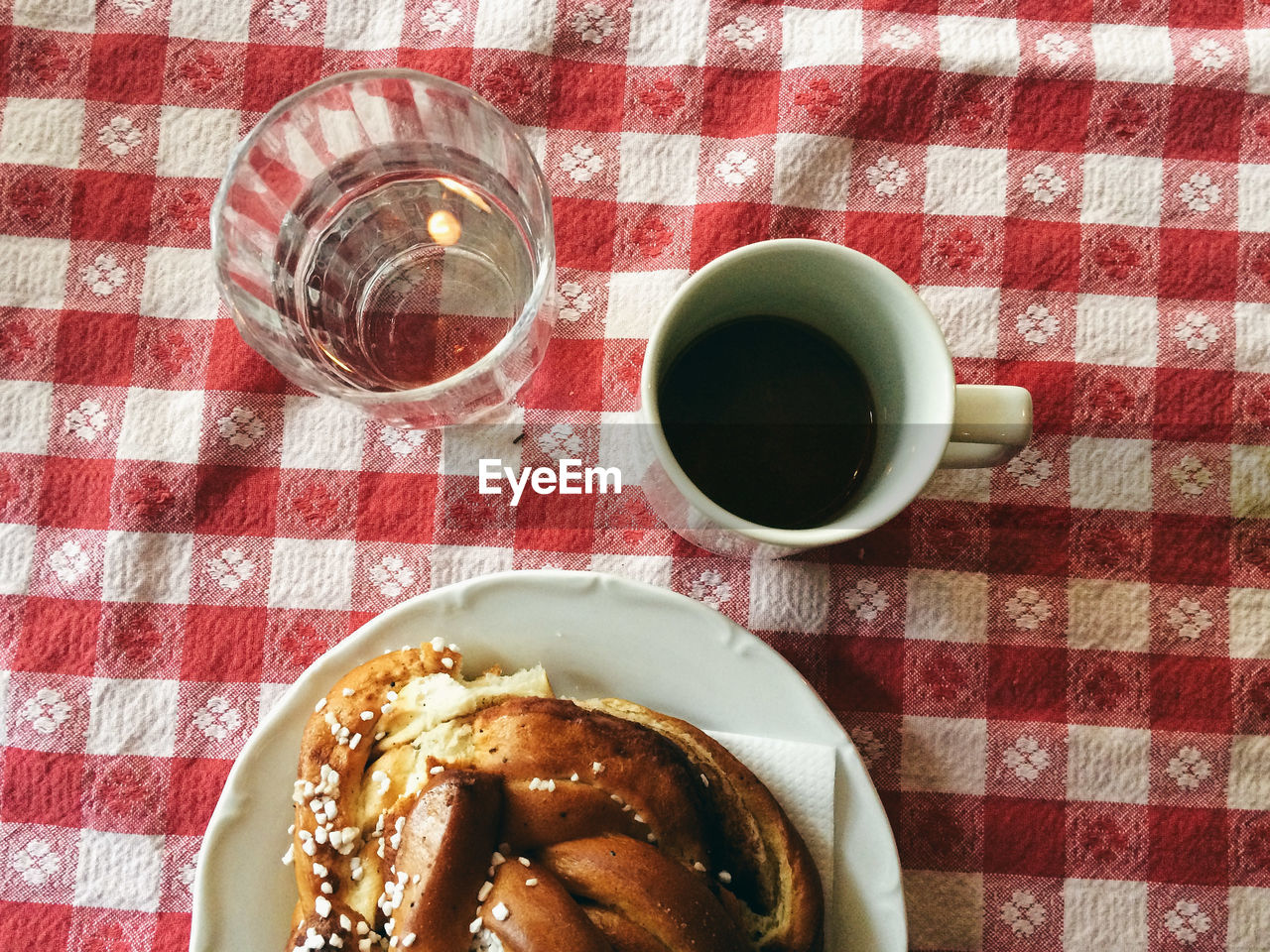 High angle view of coffee with pastry served on table