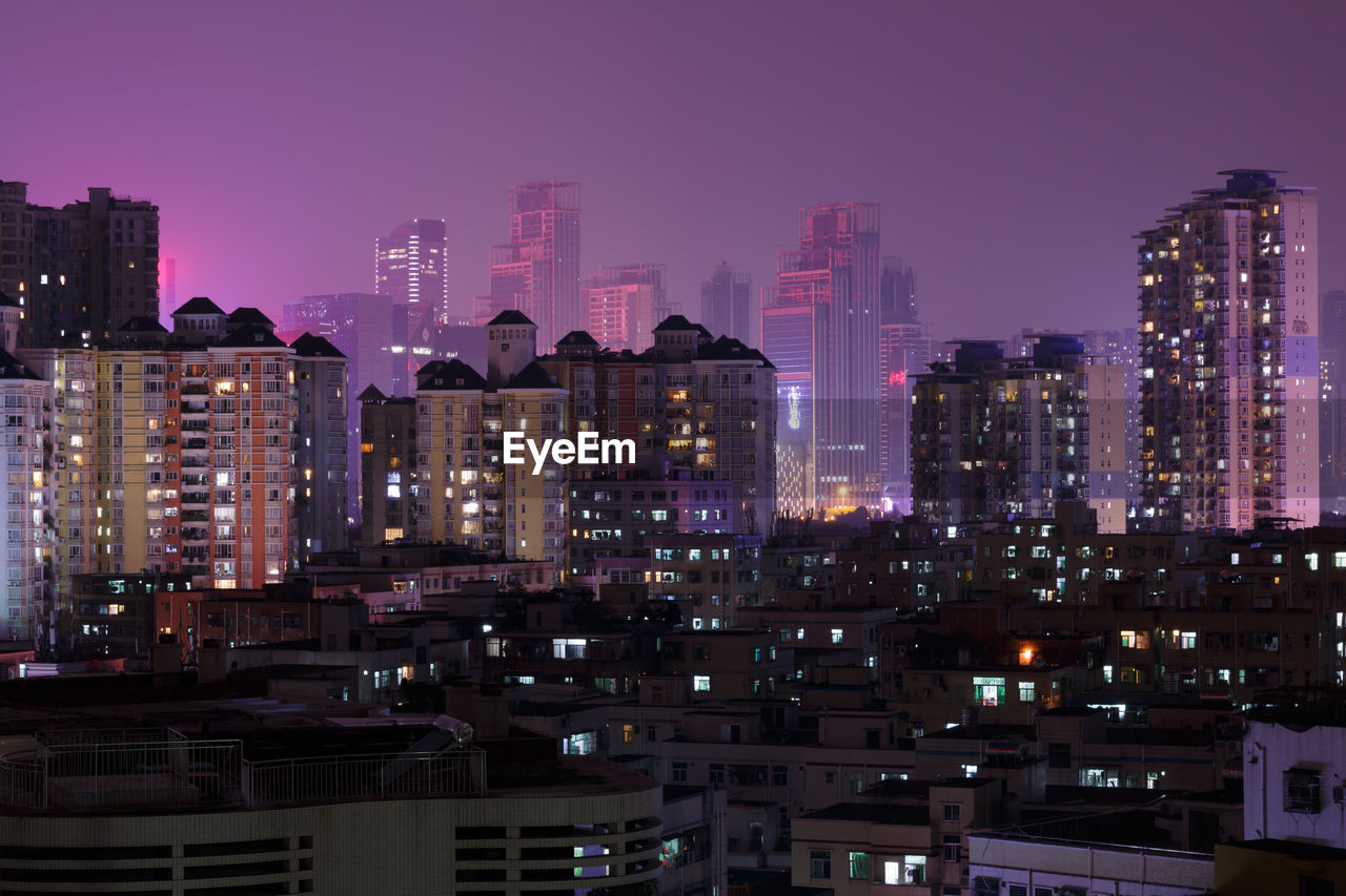 View of skyscrapers lit up at night