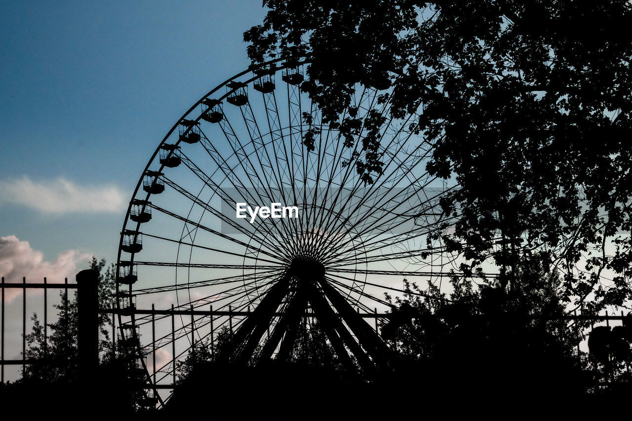 Low angle view of ferris wheel against sky