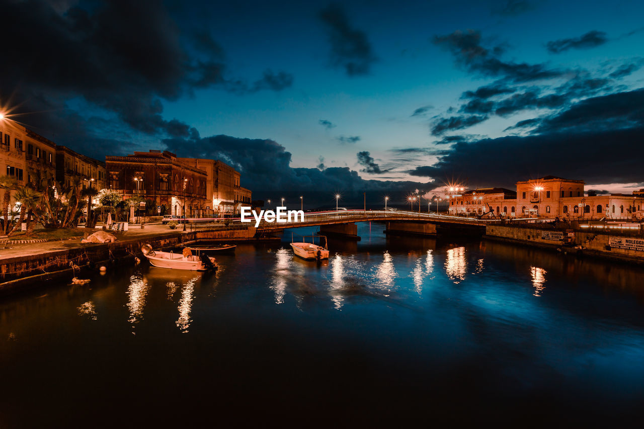 Long exposition on the illuminated harbour of ortigia, syracuse by night