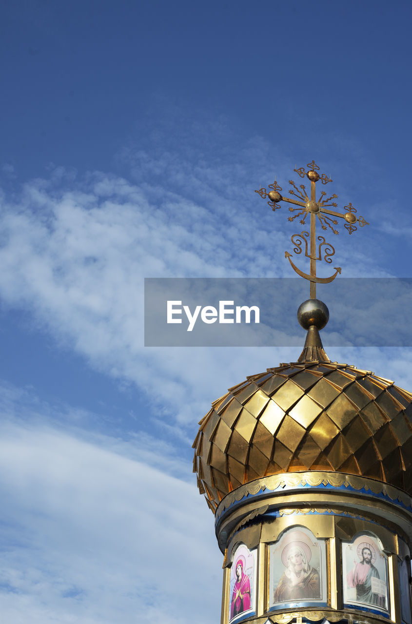 The golden dome of an orthodox village chapel against a blue sky. god. believers. vera. worship 