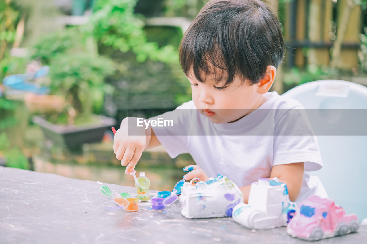 Cute boy playing with toy