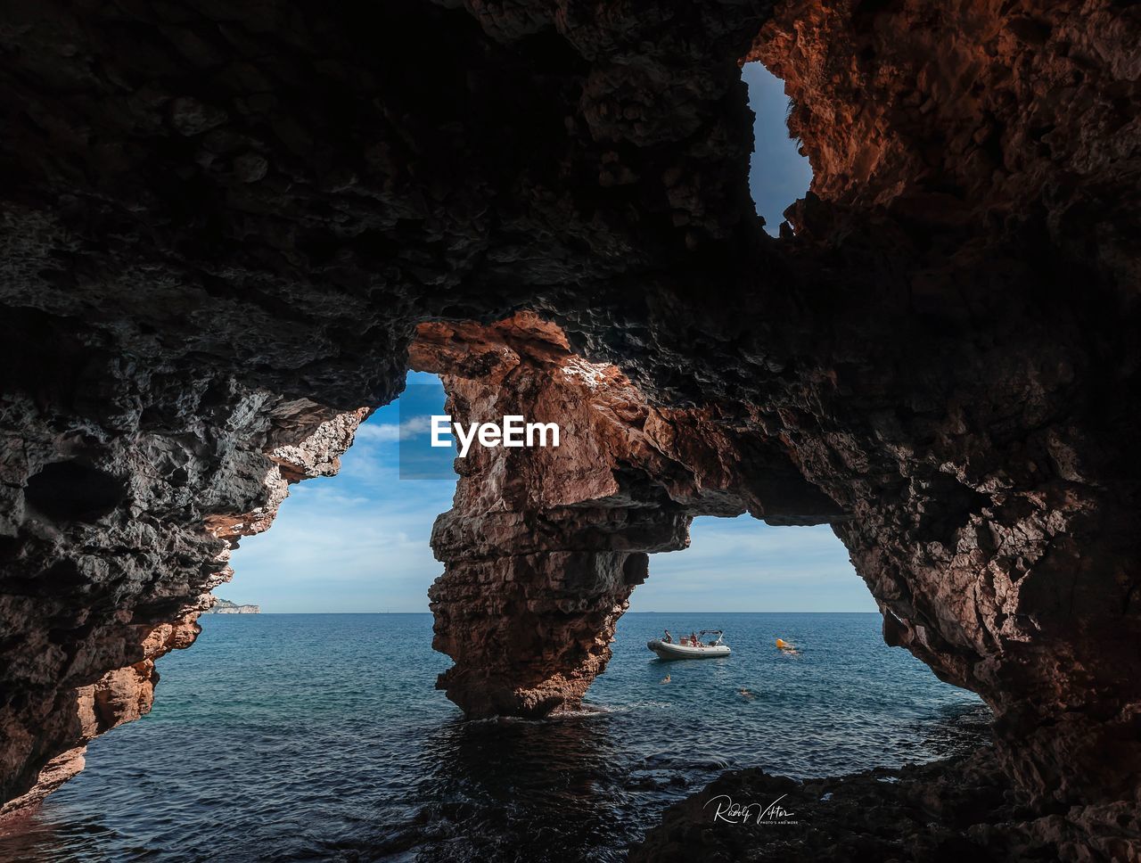 Scenic view of sea seen through cave