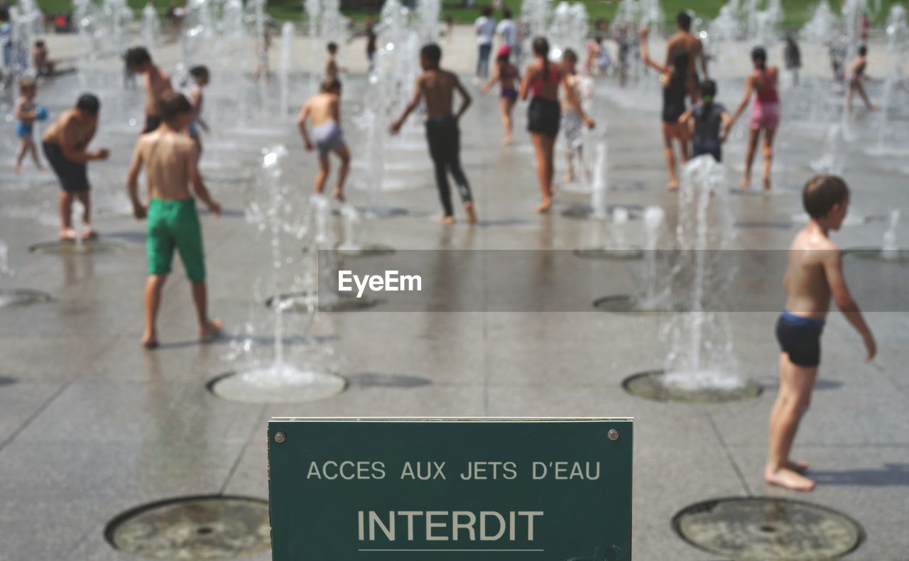 People enjoying fountain at park