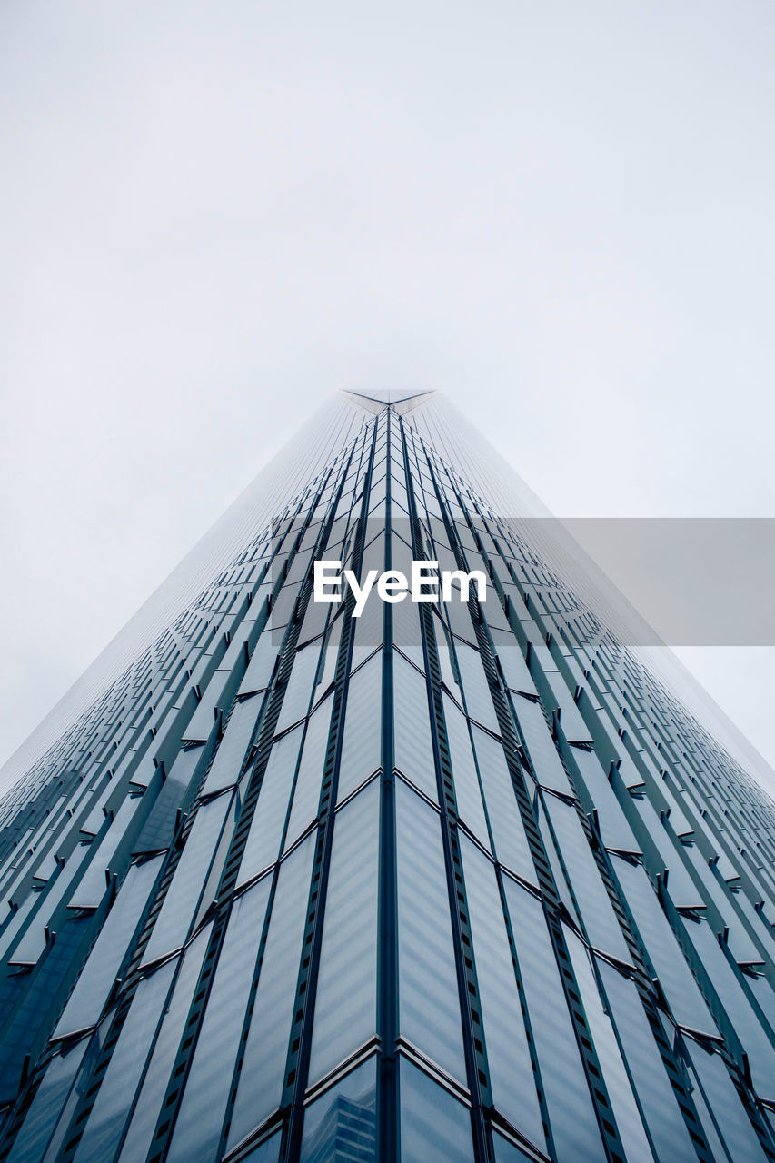 Low angle view of modern office building against sky