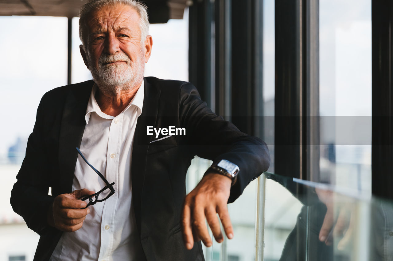 Thoughtful businessman standing in office