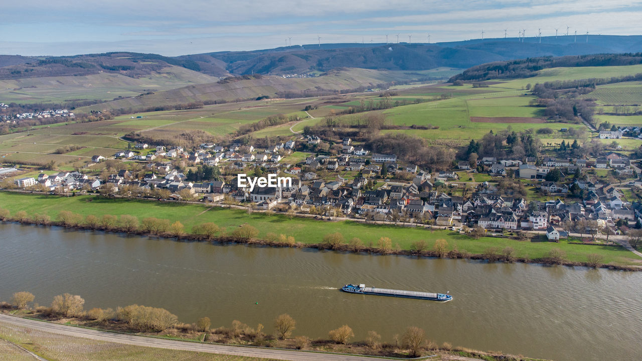 Aerial view of the river moselle valley with cargo ship and the village brauneberg